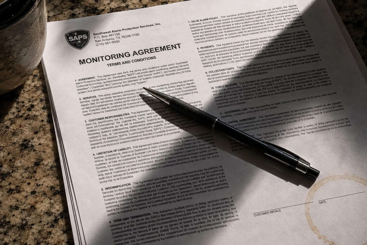Close-up of a security monitoring contract with dense fine print